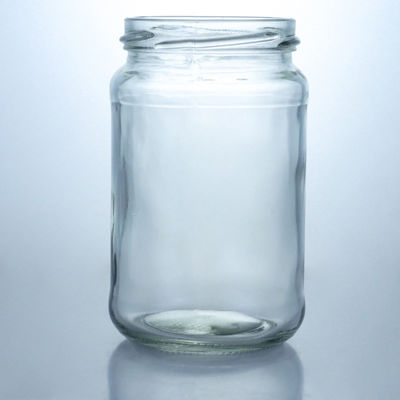 Bouteille de miel en verre ronde de 500 ml à bouche large personnalisée avec un bouchon métallique et un matériau de base en verre