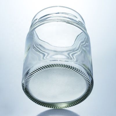 Bouteille de miel en verre ronde de 500 ml à bouche large personnalisée avec un bouchon métallique et un matériau de base en verre