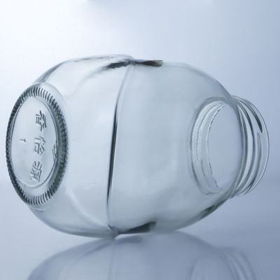 Un bocal de verre rond clair pour la manipulation de la surface décale dans une solution de production alimentaire