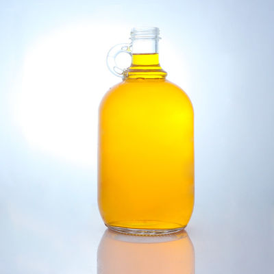Bouteille en verre de liqueur de forme ronde avec poignée et bouchon à vis