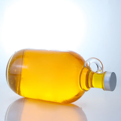Bouteille en verre de liqueur de forme ronde avec poignée et bouchon à vis